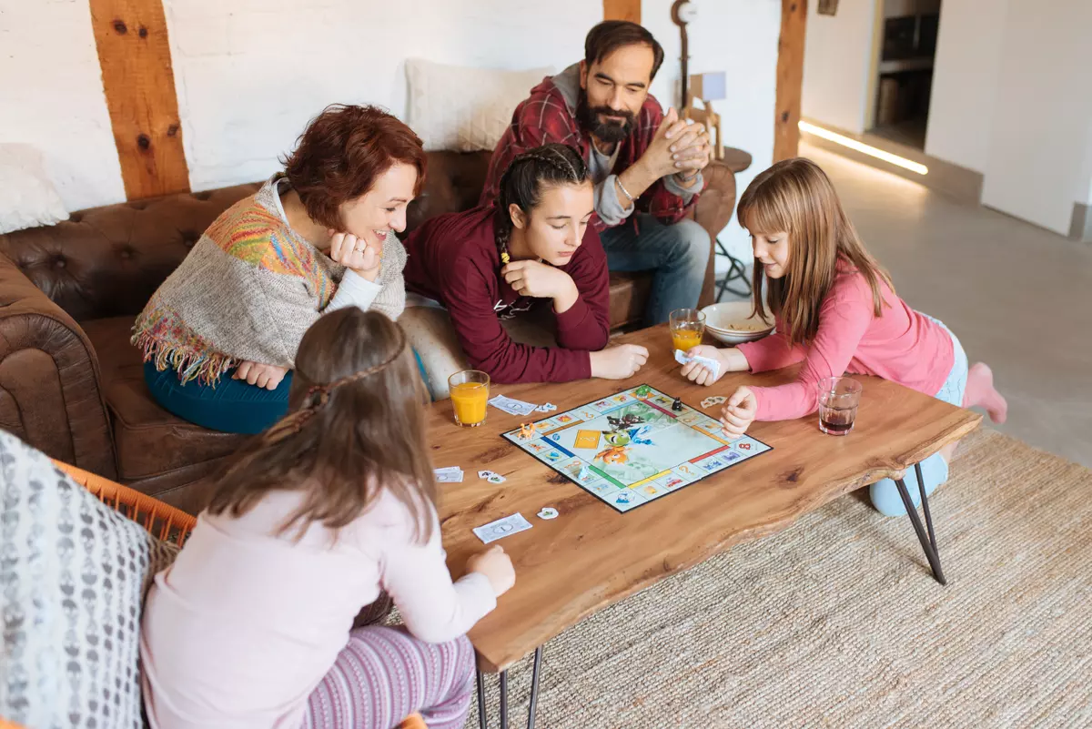 Kids having fun playing a board game with their parants