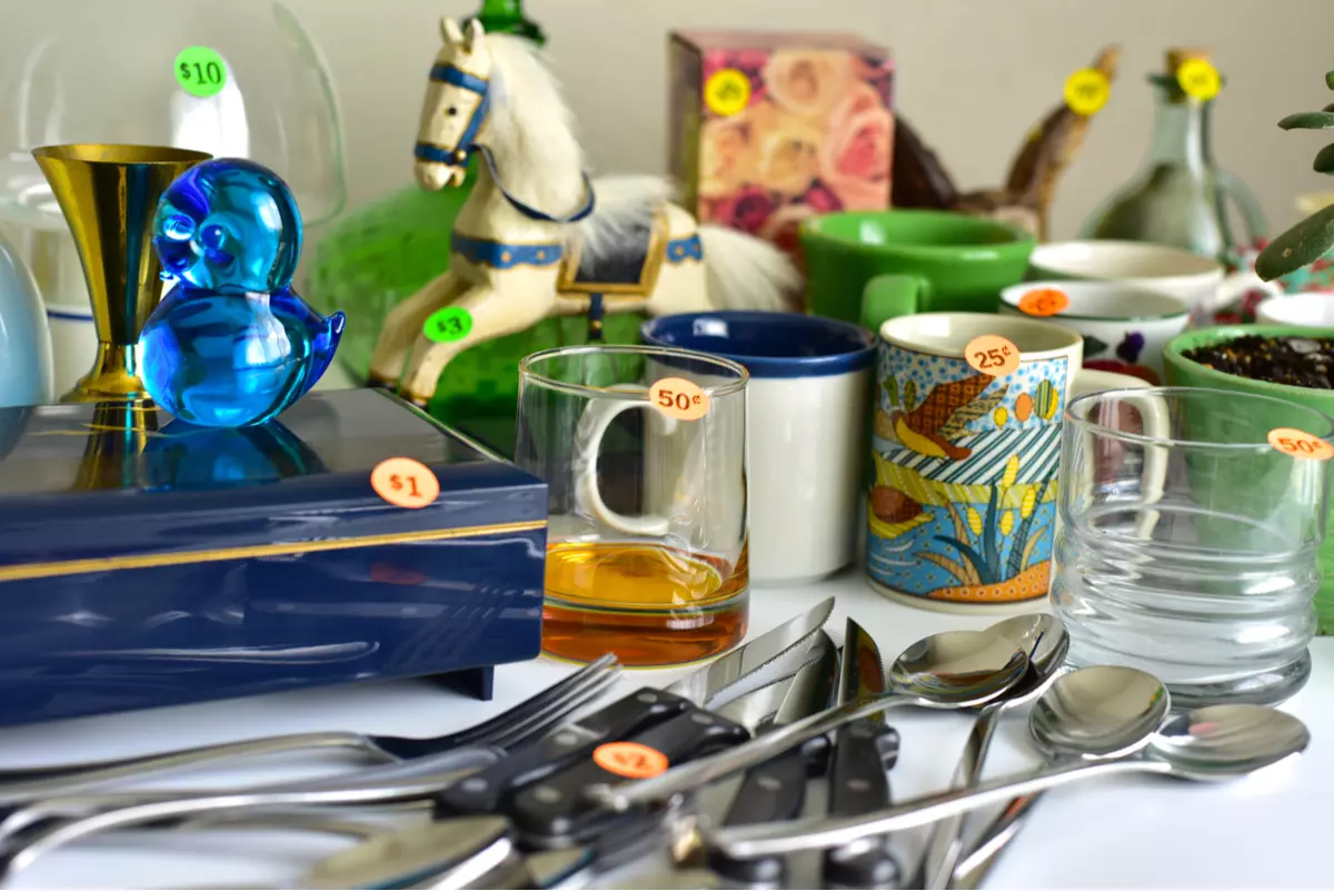 Garage sale items with price tags on a table.