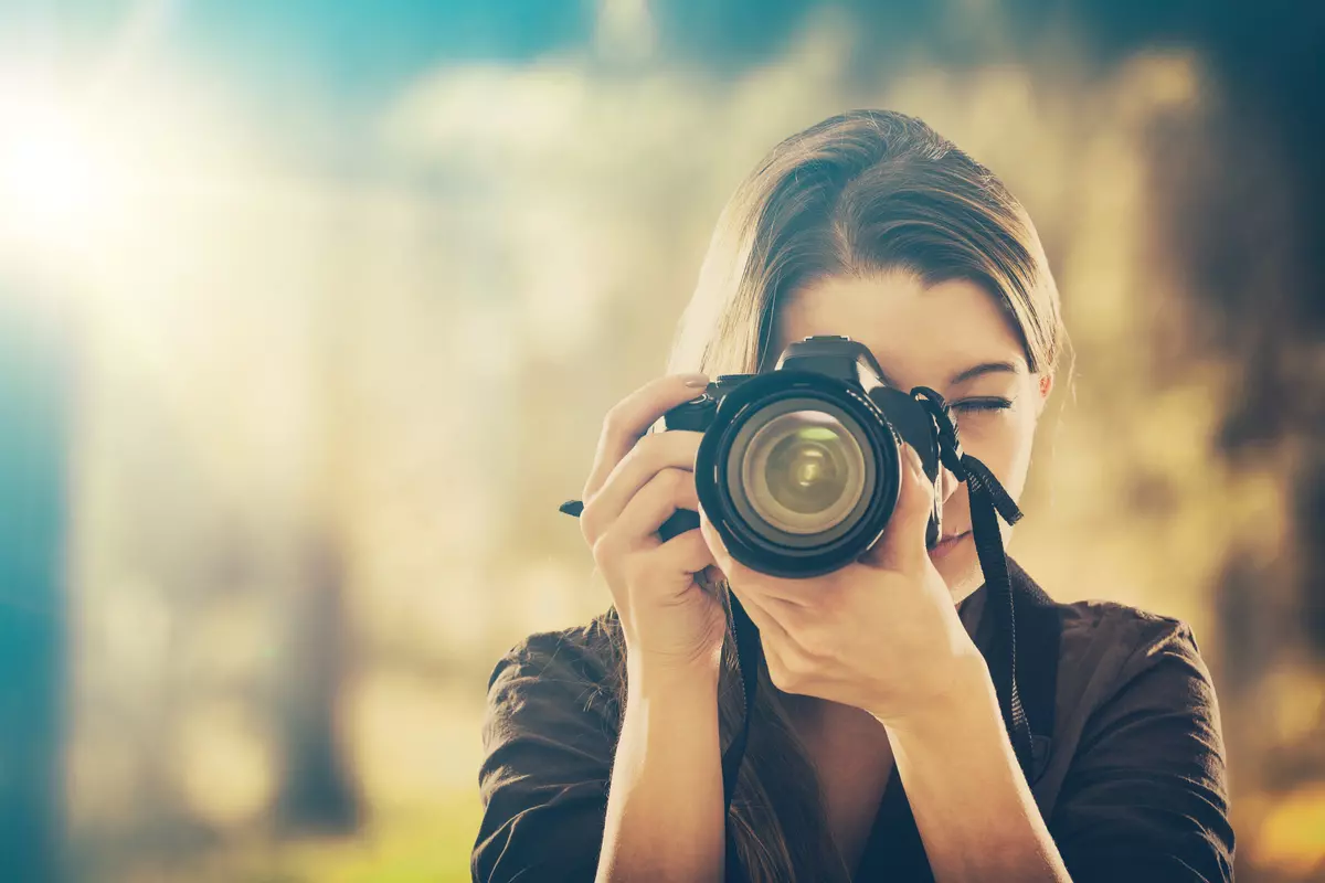 Woman taking a picture.