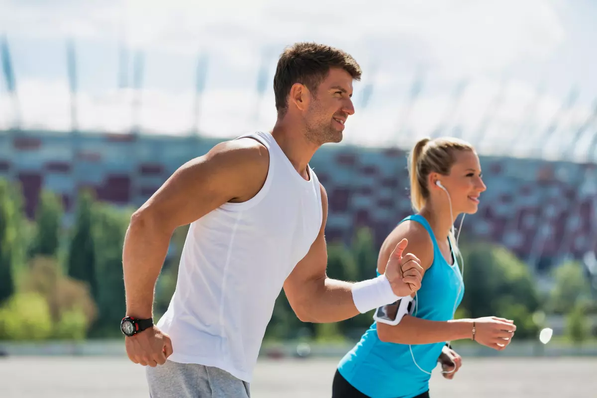 Man and woman running outside.