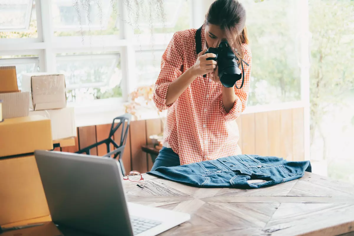 Woman taking a photo of a clothing to sell online