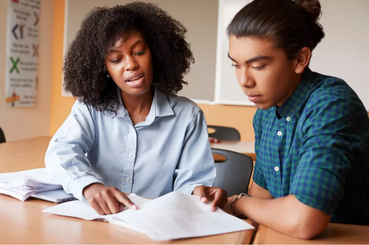 Woman helping teach a student.