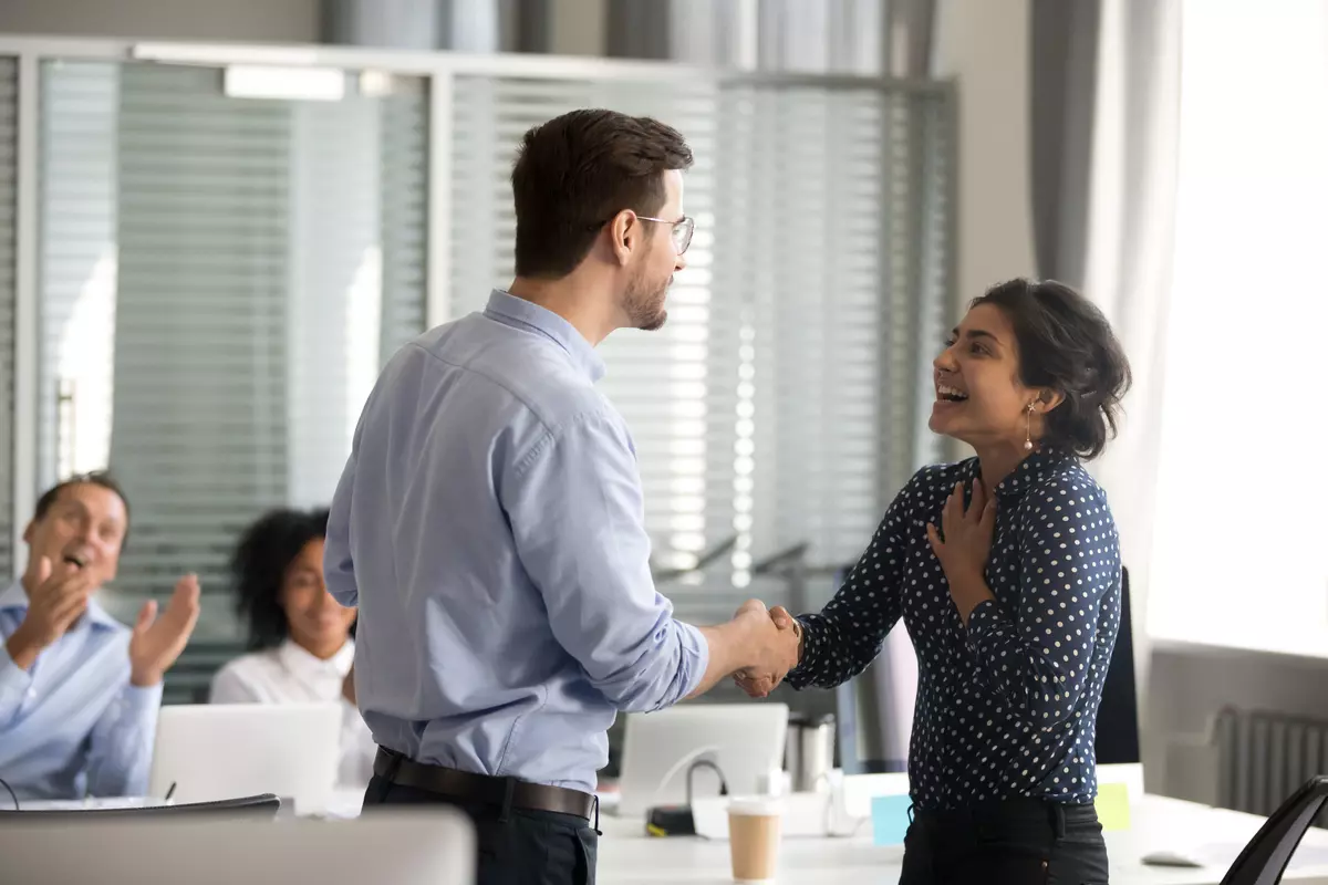 Woman getting praised at work.