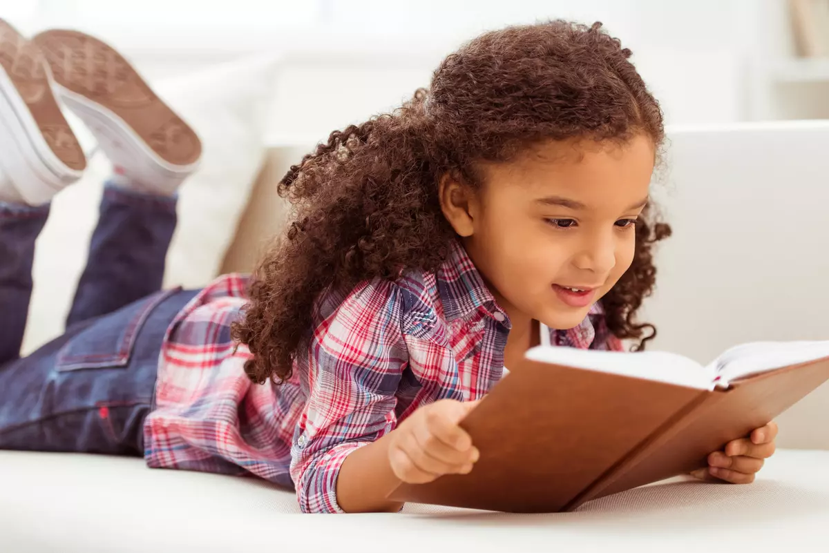A young girl reading a book.