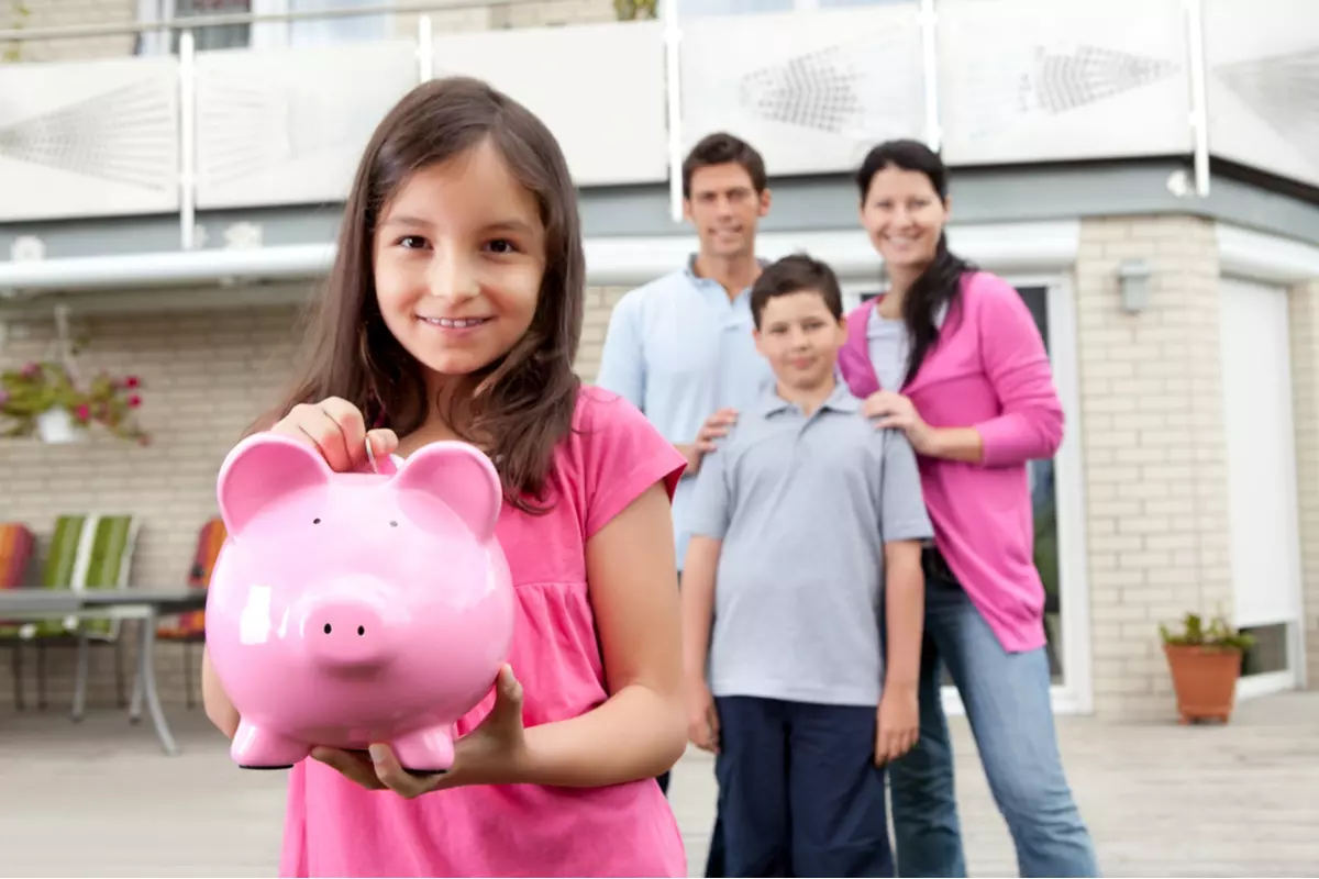 A child holding a piggy bank.