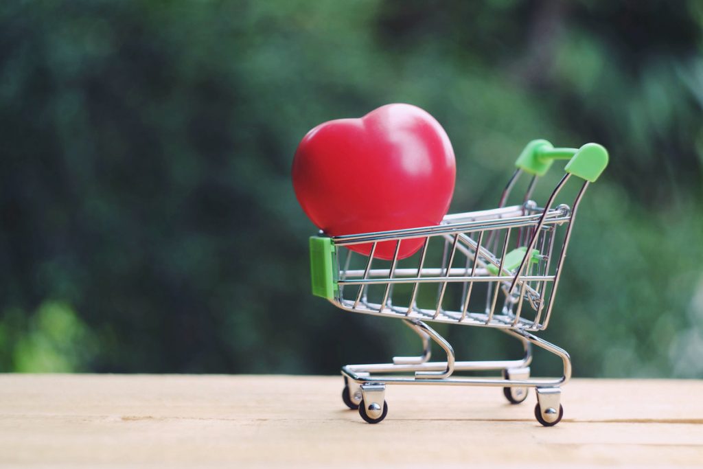 A tiny shopping cart with a heart inside.