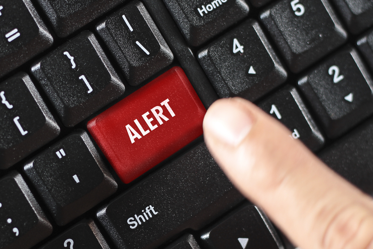 The word alert in red on a keyboard