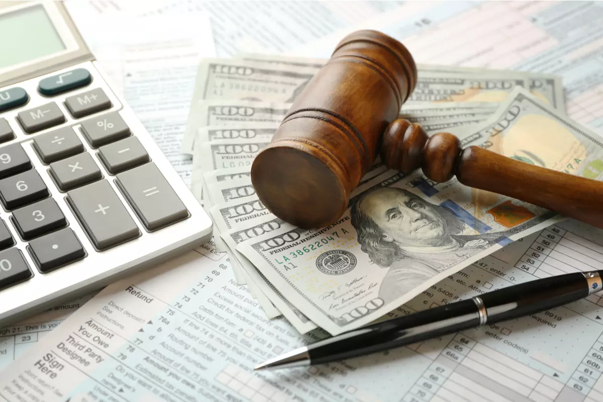 A judge's gavel on a pile of banknotes. 