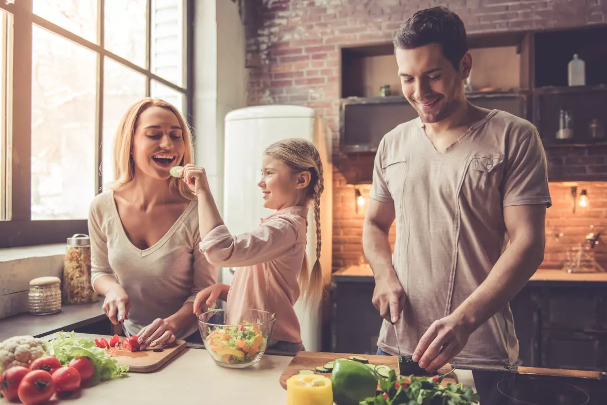 A family cooking a healthy meal together.