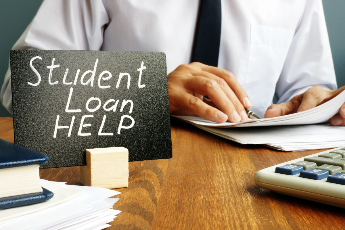 A financial advisor with a sign that says "student loan help" 