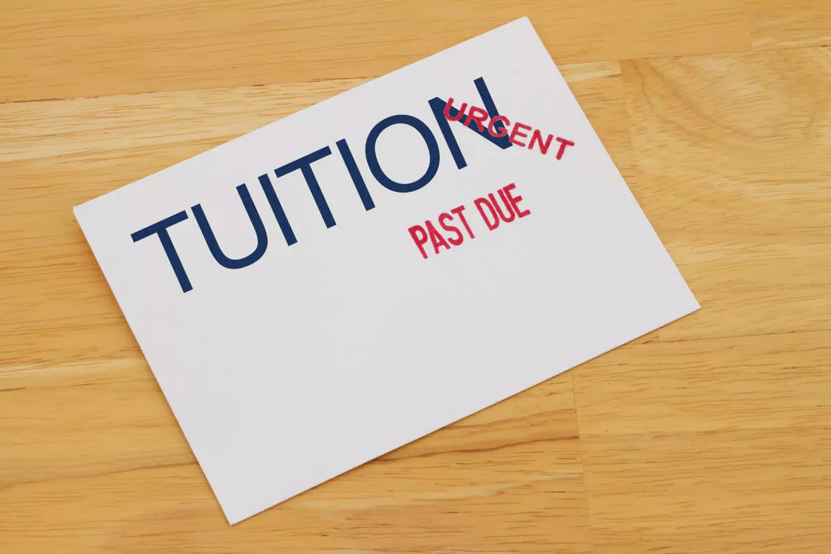 An envelope with the words "tuition past due"