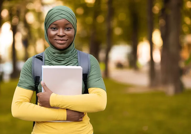 Young happy woman with papers in her hands.