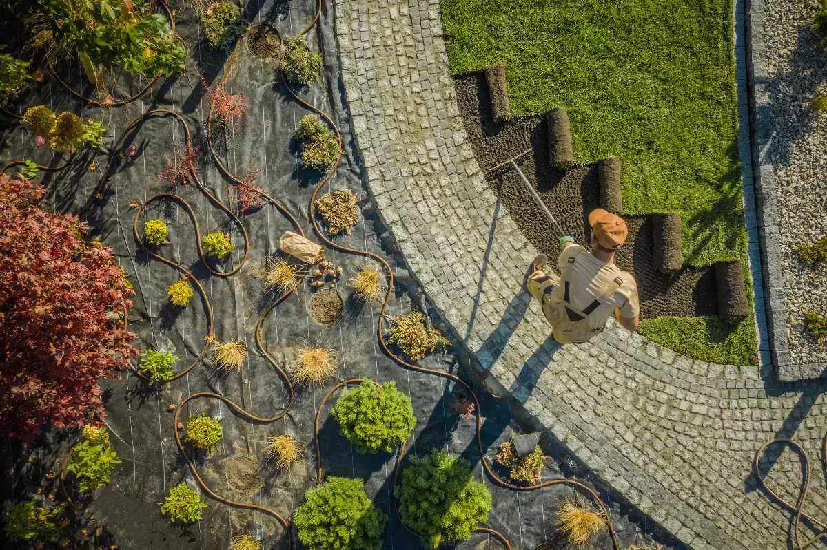 Aerial view of landscaper working on lawn.