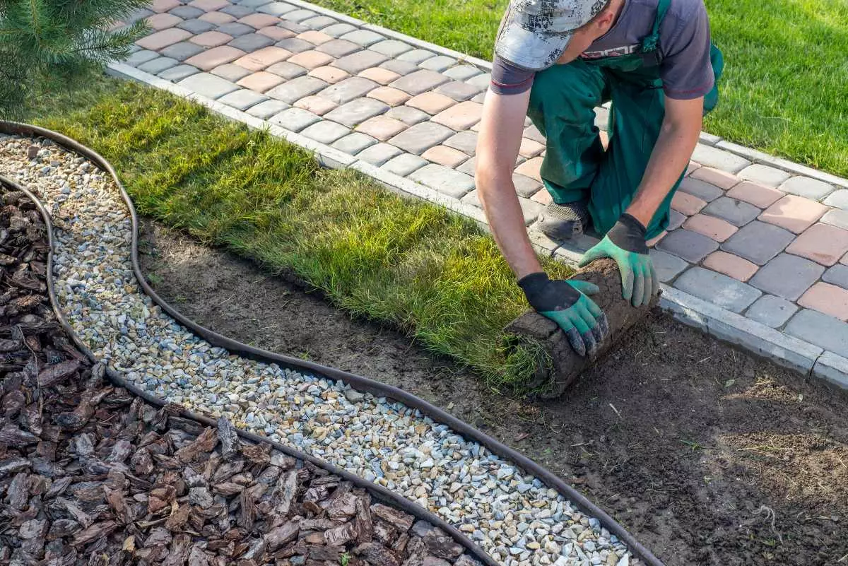 Landscaper spreading new grass.