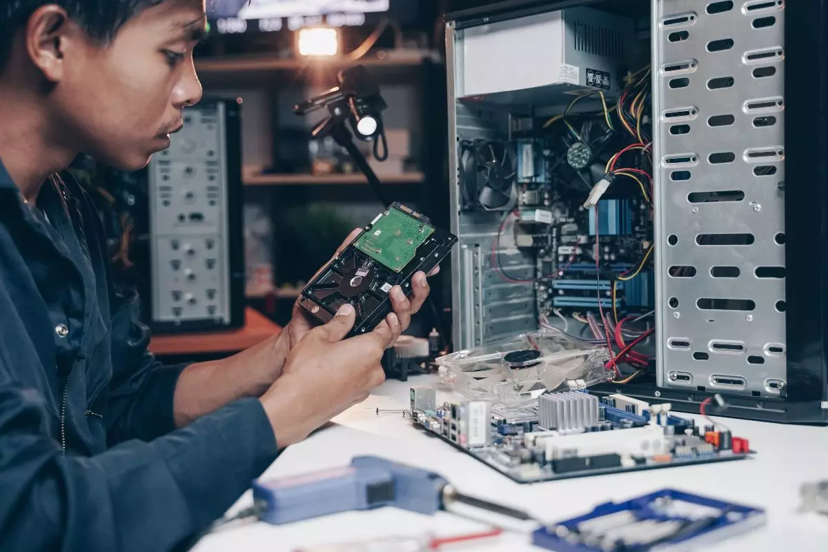 Computer technician repairing computer.