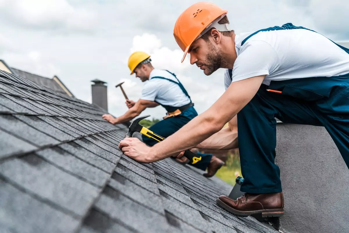 Construction crew remodeling roof.