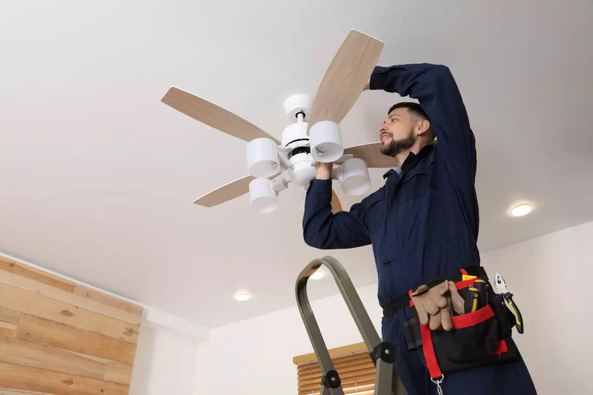 Professional installing ceiling fan.