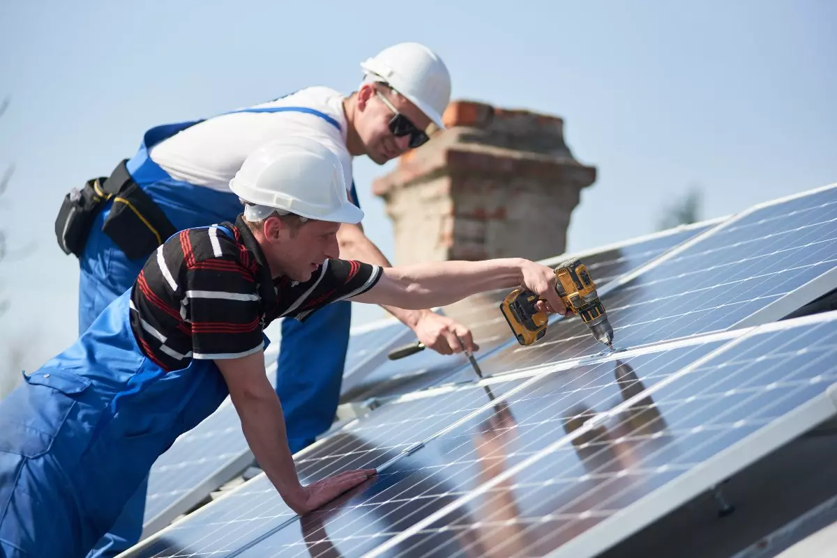 Professionals installing solar panels.