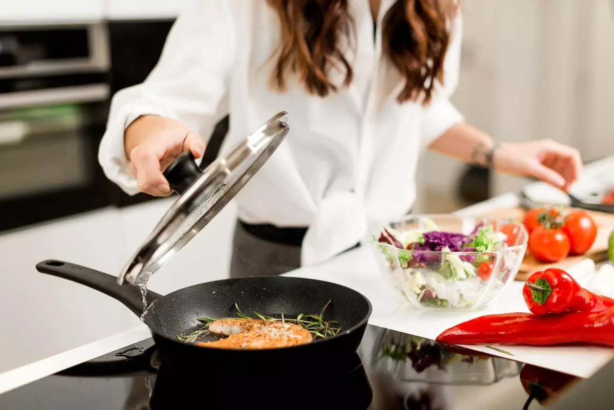 Close up on individual cooking at home.