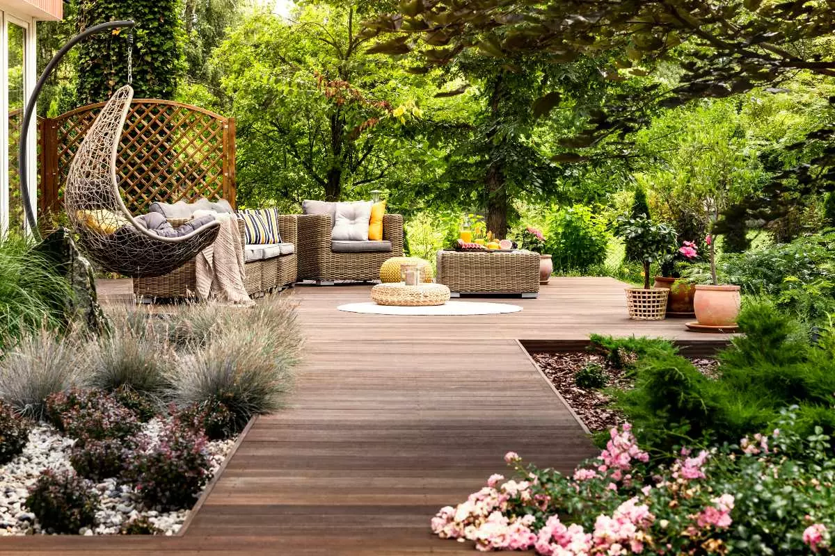 Outdoor patio surrounded by plants. 