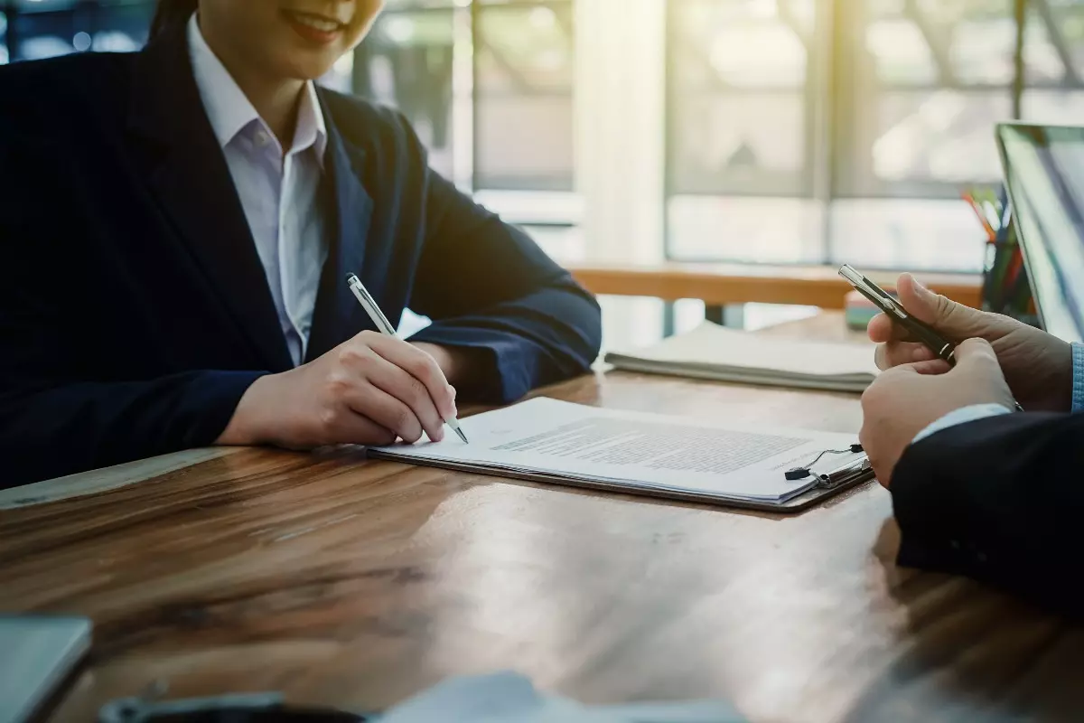 Business professional signing documents.