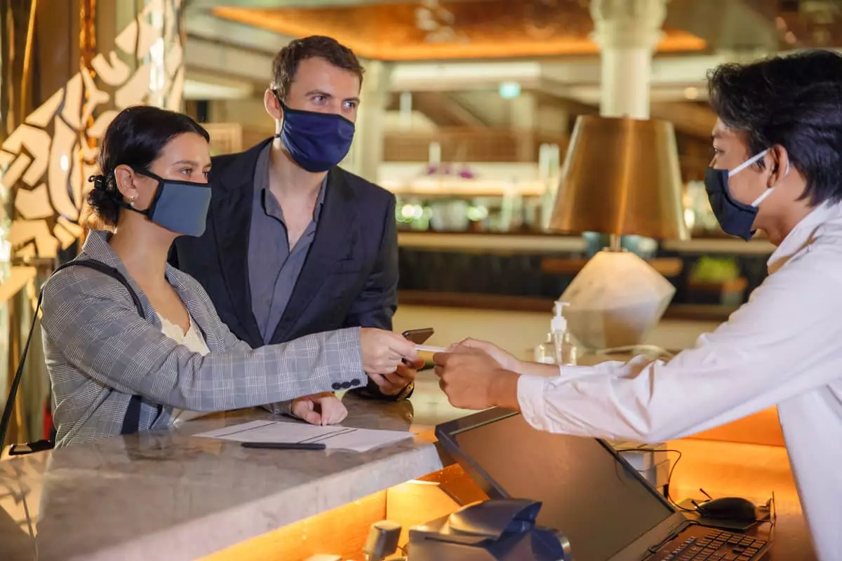 Couple checking in in hotel reception