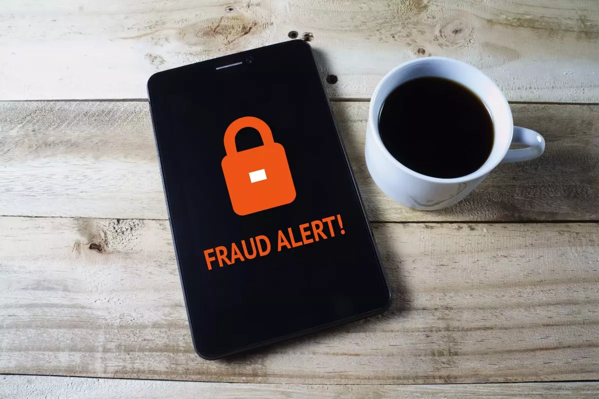 Close up on fraud alert on cellphone
