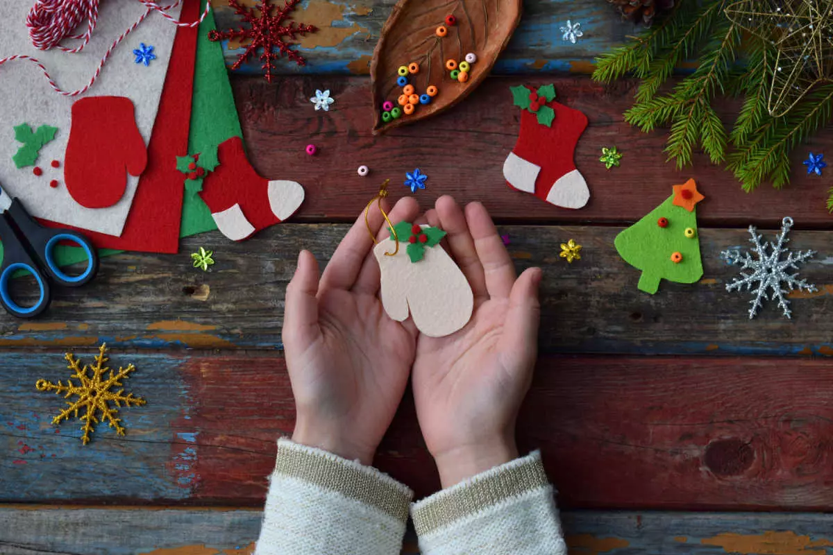 Close up on hands holding homemade holiday ornament