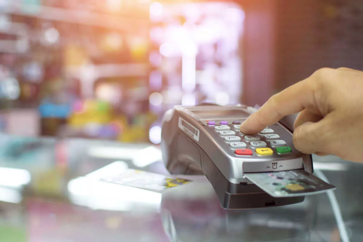 Close up on cardholder entering debit card PIN