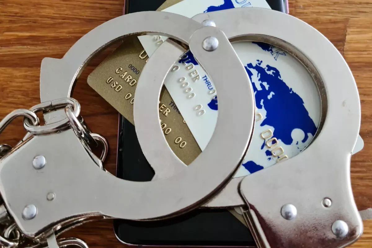 Credit card bound with handcuffs symbolizing credit card fraud punishment