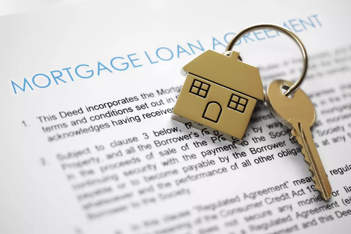 Close up on mortgage loan agreement and keys