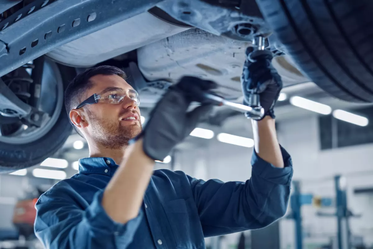 Auto mechanic repairing car