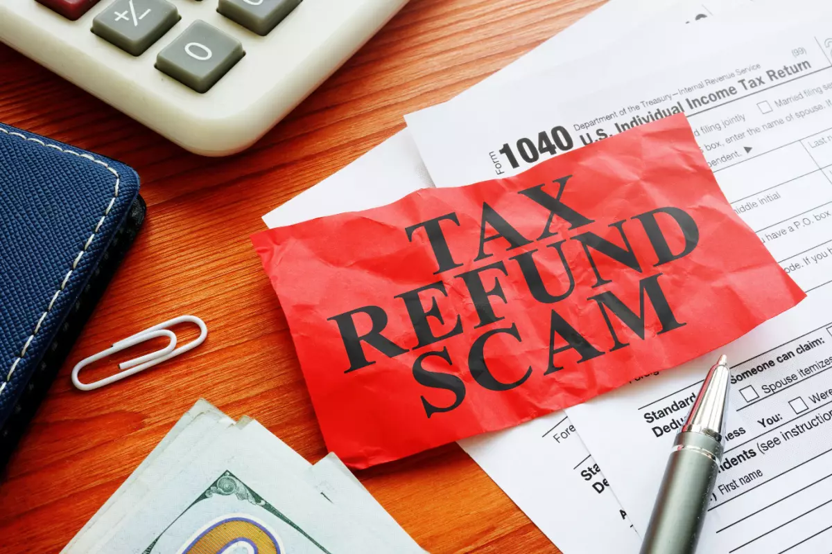 Tax refund scam paper on top of IRS forms