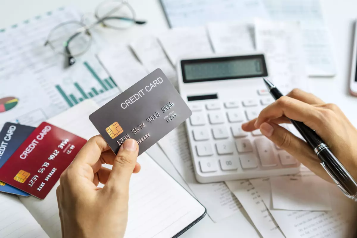 Businessperson calculating credit card bill