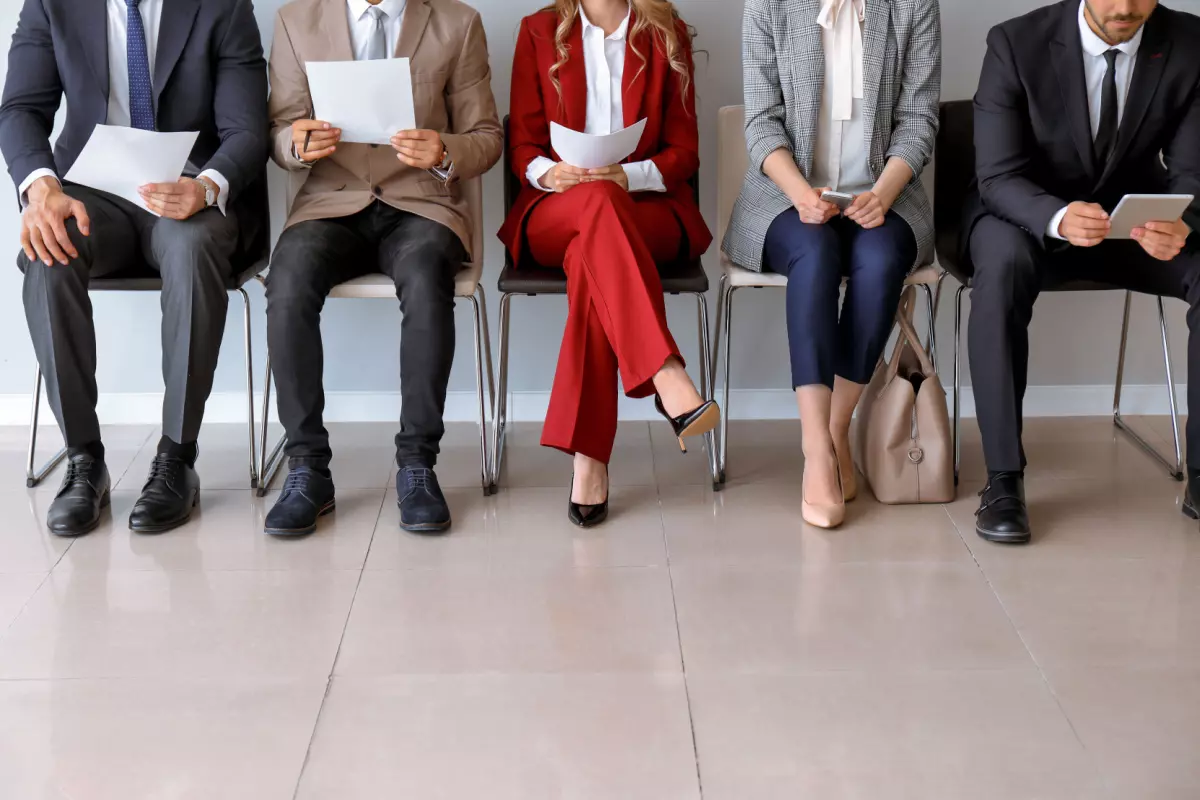 Job applicants sitting waiting for interview