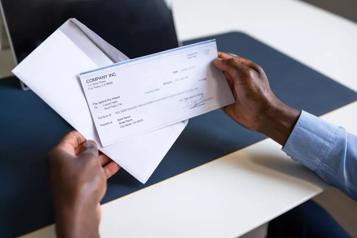Business owner holding paycheck 