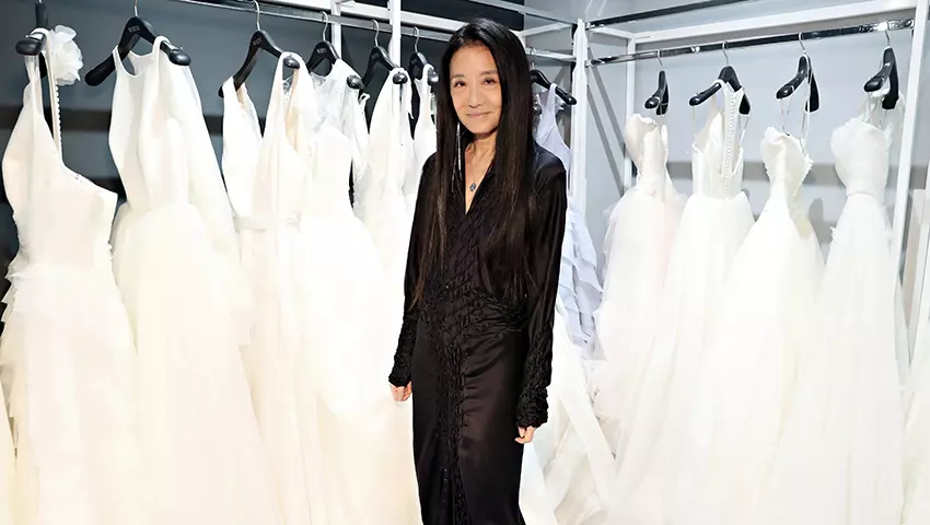 Vera Wang standing in front of wedding gowns