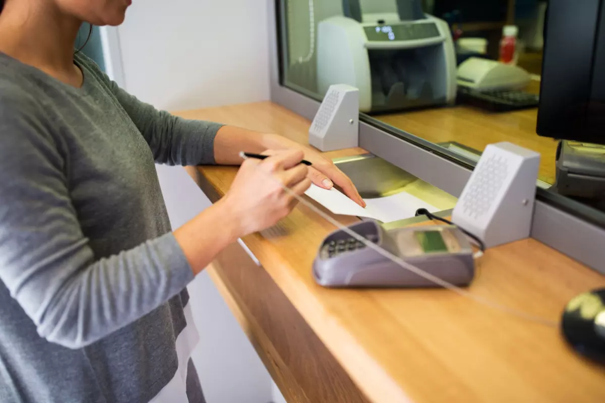 Cardholder signing paperwork at bank 