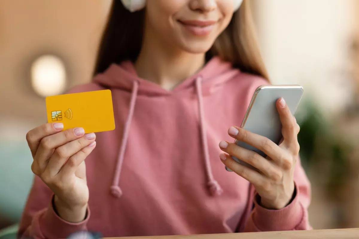 Teen holding credit card