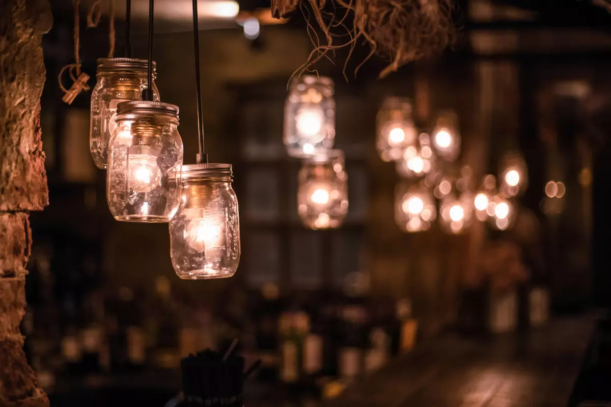 Mason jar lanterns hanging from trees 