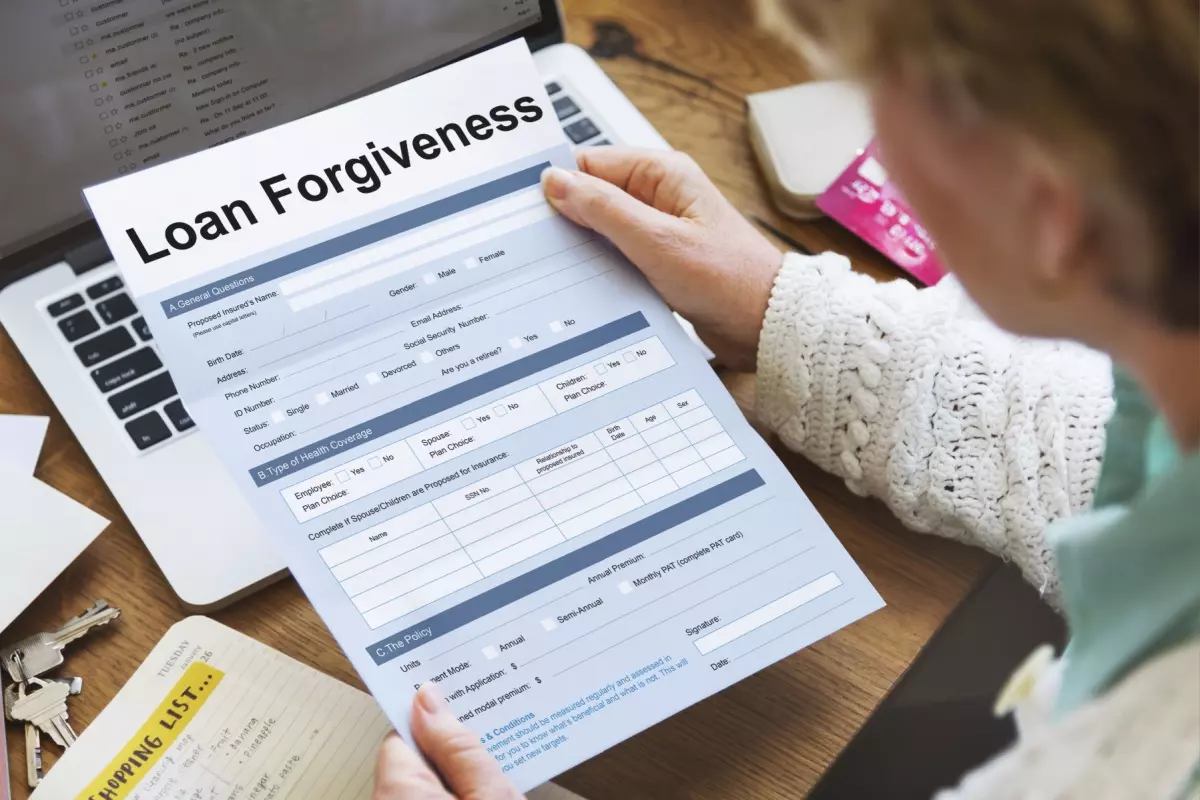 Elderly adult reviewing loan forgiveness application